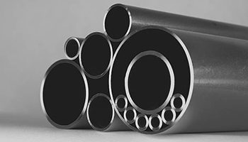 Assortment of high-quality special alloy pipes and tubes on gray background.