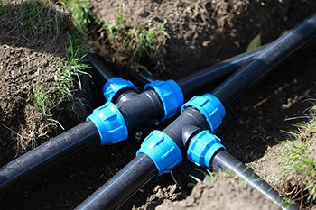 Plastic tubes with blue connectors for Water Utilities installation in ground