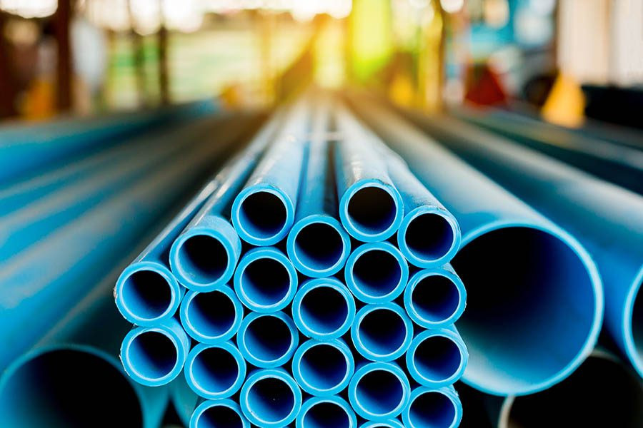 Stack of blue PVC pipes from a reliable PVC pipe supplier