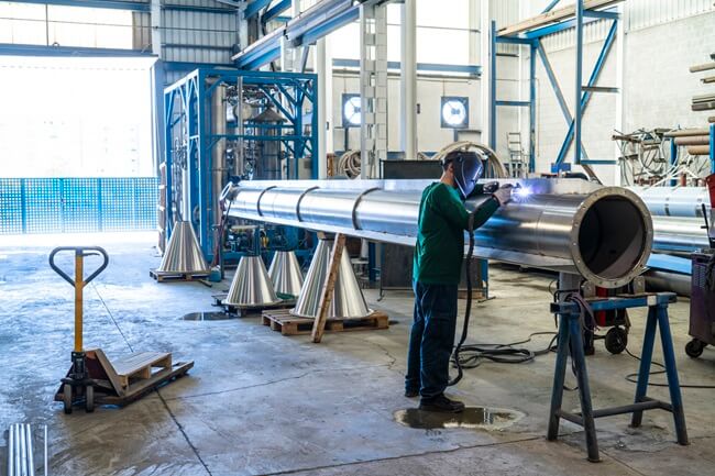 Industrial welder works on stainless steel strengthened by nickel